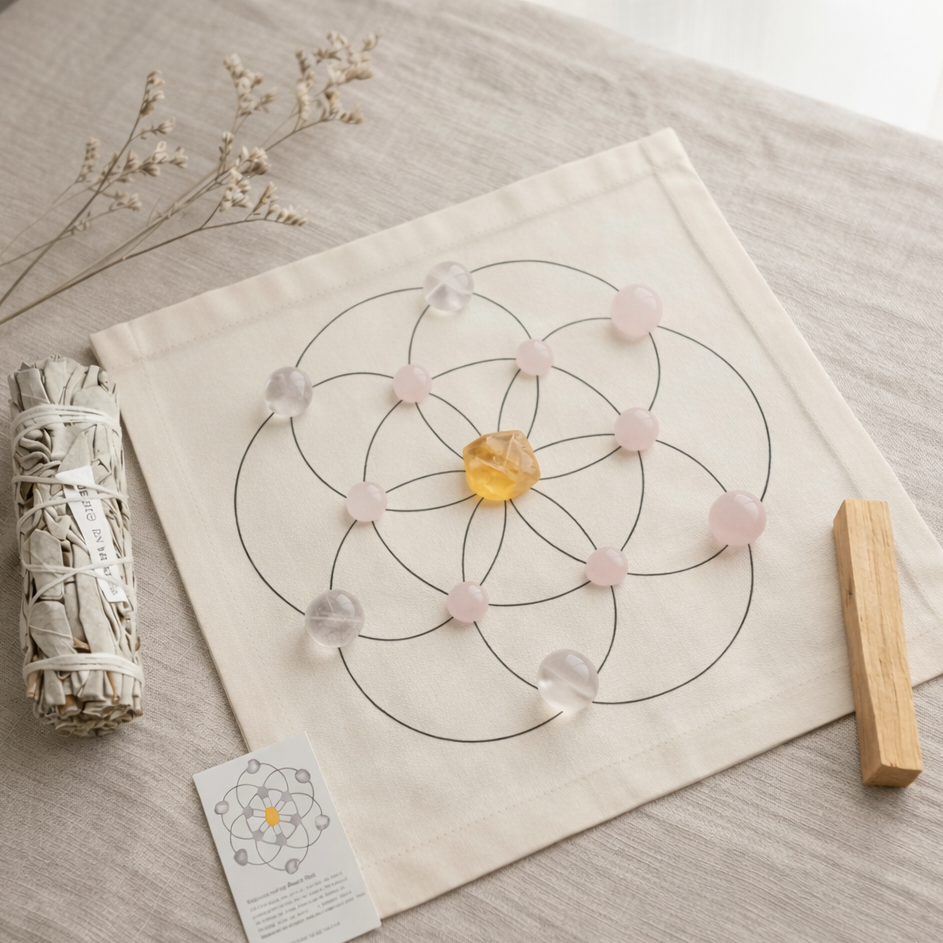 Love and harmony ritual crystal grid with rose quartz stones, smudge stick, and wooden tool on natural surface