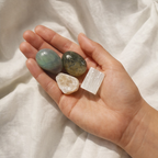 Cleansing crystals from renewal intention kit on white fabric background